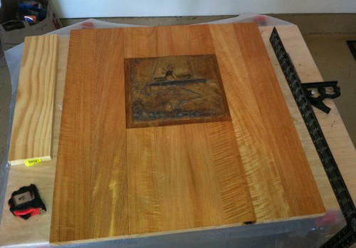 Mahogany boards cut and joined around the relief.